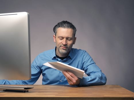Handsome businessman with a paper plane, start up or upswing concept