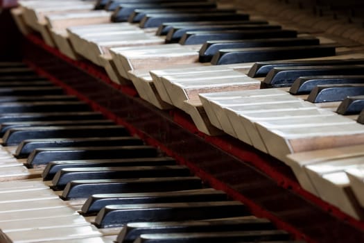 Abstract detail of old, broken and dusty organ keys.