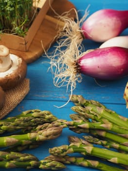 Healthy food concept with organic vegetables on a rustic wooden table, natural light with selective focus