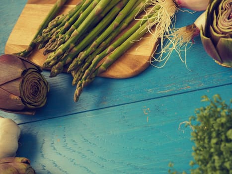 Healthy food concept with organic vegetables on a rustic wooden table, natural light with selective focus, vintage color toned