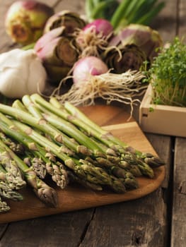 Healthy food concept with organic vegetables on a rustic wooden table, natural light with selective focus