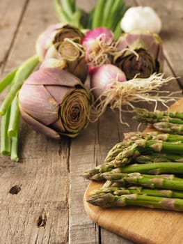 Healthy food concept with organic vegetables on a rustic wooden table, natural light with selective focus