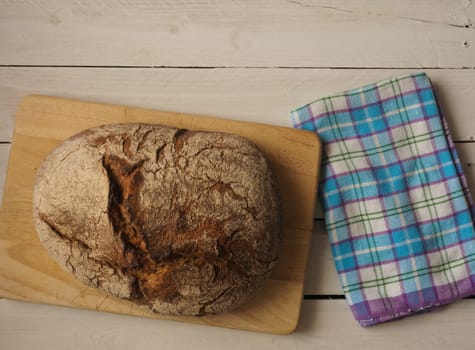 Tasty bread on a rustic wooden background with space for text, view from above