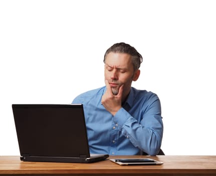 Handsome business man working on an office table with a laptop