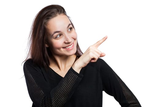 Attractive young woman pointing at copy space, isolated on white