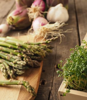 Healthy food concept with organic vegetables on a rustic wooden table, natural light with selective focus