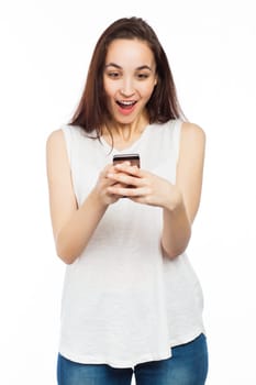 Young woman looking surprised using her phone, isolated on white