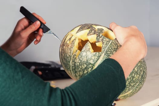woman hands making pumpkin for halloween holidays.