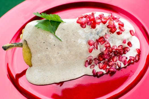 Chiles en nogada is a dish, served at room temperature with cold cream sauce, from Mexican cuisine.