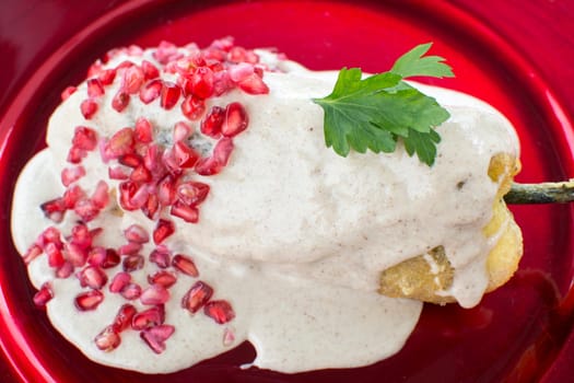 Chiles en nogada is a dish, served at room temperature with cold cream sauce, from Mexican cuisine.