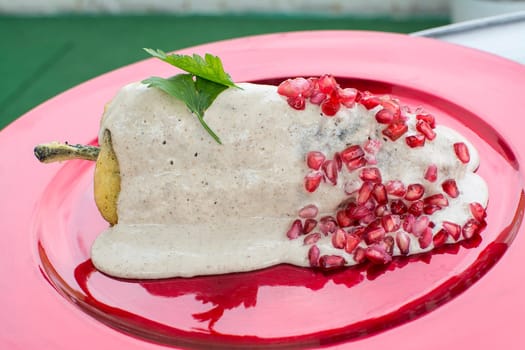 Chiles en nogada is a dish, served at room temperature with cold cream sauce, from Mexican cuisine.