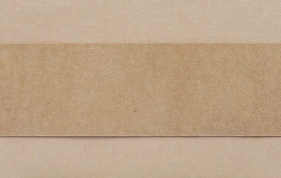 Blank dark brown paper on light brown cardboad background
