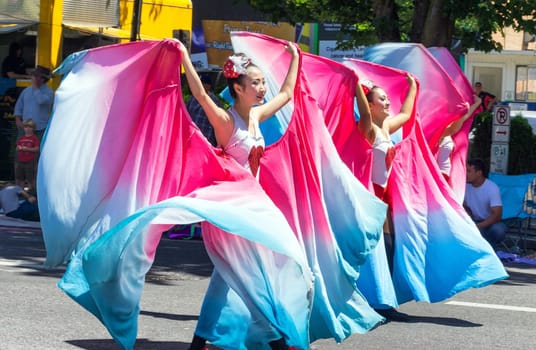 PORTLAND, OR - JUNE 6: Dancers perform in the Grand Floral Parade as part of the Rose Festival in Portland, Oregon on June 6, 2015