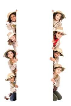 Children's group with safari clothes and gear over a white board