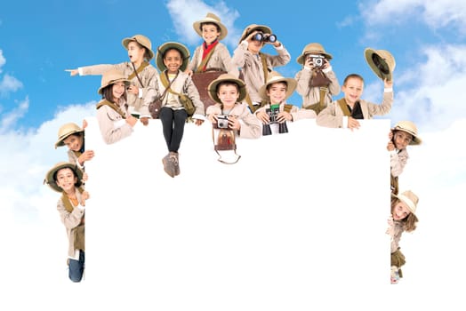 Children's group with safari clothes and gear over a white board