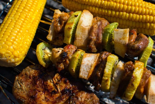 close on meat with fruits and vegetables on the grill,top view