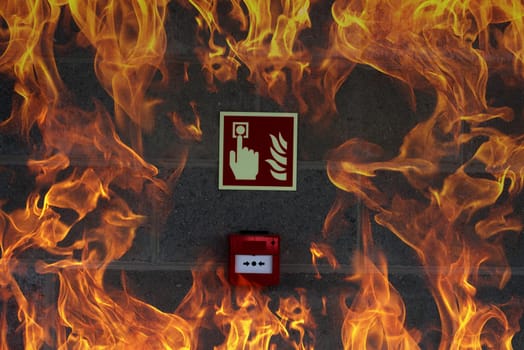 emergency fire exit on the stone wall with fire flames
