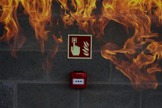 emergency fire exit on the stone wall with fire flames