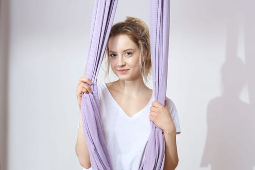 a woman is practicing yoga on a hose,aerial yoga