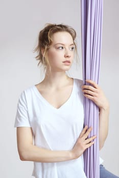 a woman is practicing yoga on a hose,aerial yoga