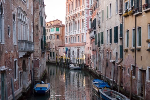 canal with boats in Venice colorful facades of old buildings