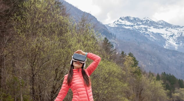young woman in the nature with VR glasses