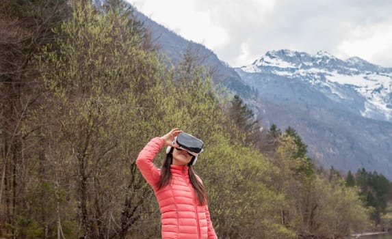 young woman in the nature with VR glasses