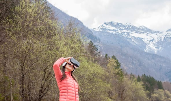 young woman in the nature with VR glasses