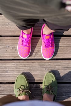 woman and man standing close feet shoes together top view