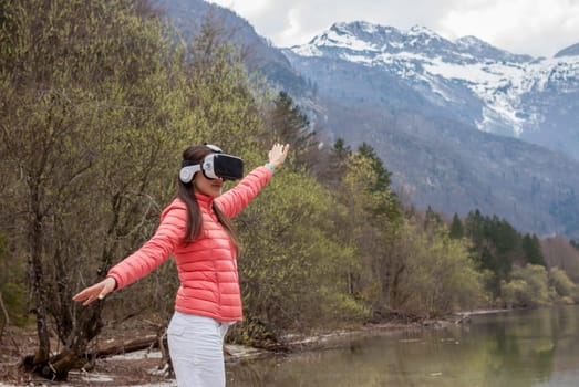 young woman in the nature with VR glasses