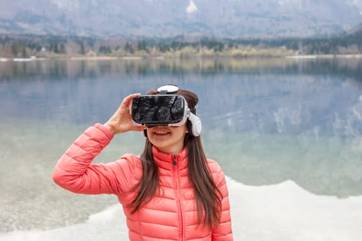young woman in the nature with VR glasses