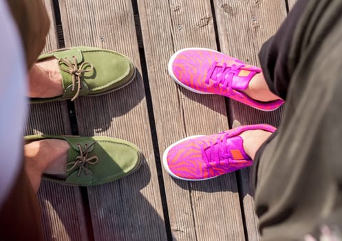 woman and man standing close feet shoes together top view