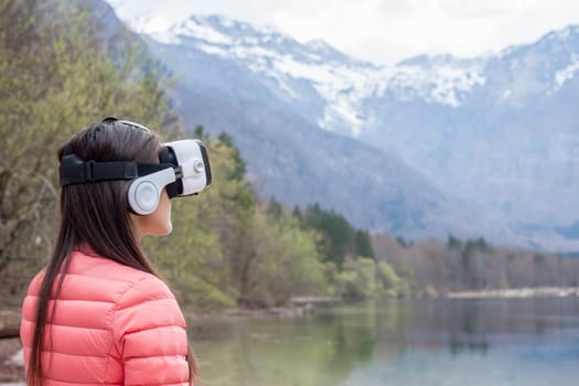 young woman in the nature with VR glasses