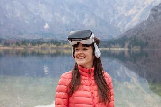 young woman in the nature with VR glasses