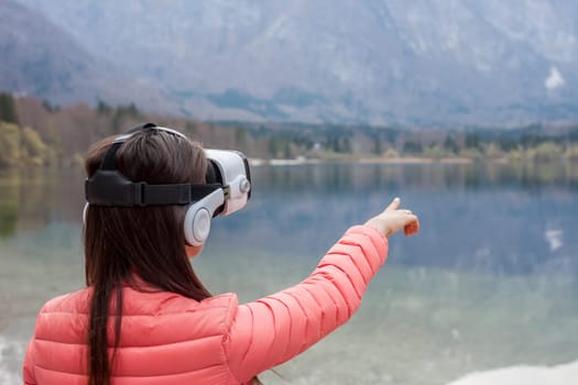 young woman in the nature with VR glasses