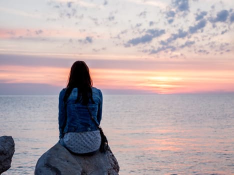 colorful beautiful sunset over Adriatic sea woman looking at horizon