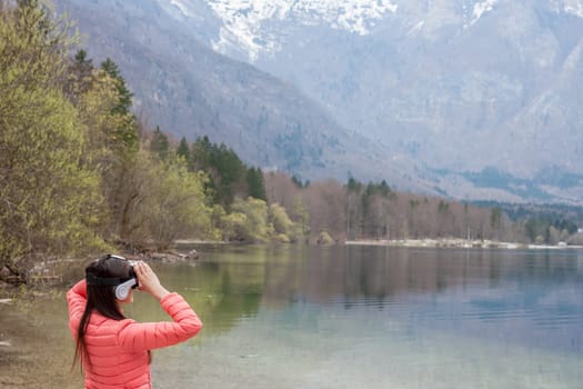 young woman in the nature with VR glasses