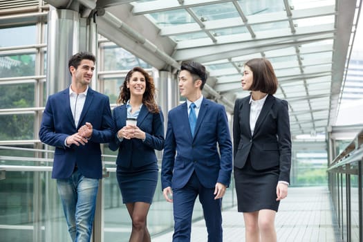 Group of business people walking on bridge in Hong Kong