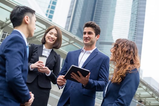 Group of business people discuss on digital tablet
