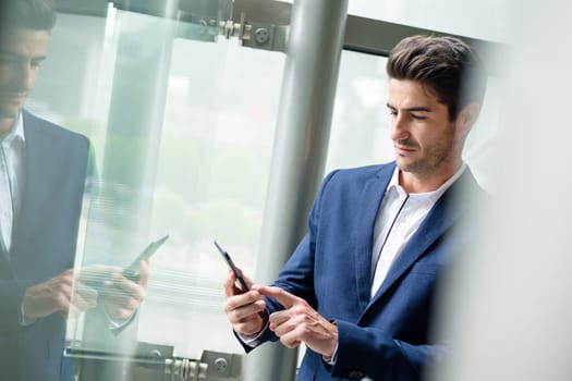 Businessman use of cellphone inside office