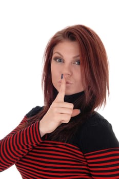 A pretty woman in a red and black striped dress holding her finger over.her mouth, isolated for white background..