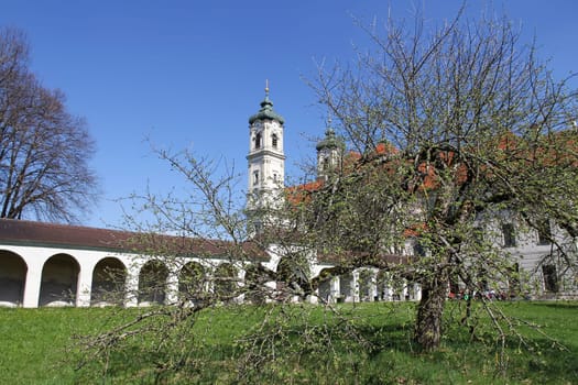 Monastery garden of the Benedictine Abbey of Ottobeuren. The church and the garden of the monastery in Ottobeuren