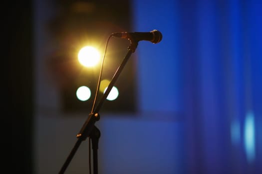 Microphone on the rack in the concert stage. Shallow depth of field. Selective focus.