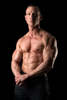 Power athletic man with great physique. Strong bodybuilder with six pack, perfect abs, shoulders, biceps, triceps and chest.