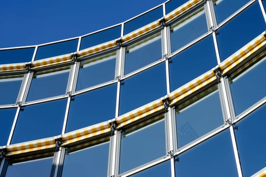 Modern façade of a building with roller blinds as sun protection