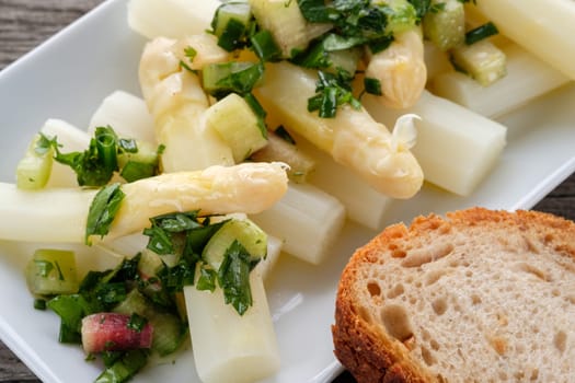 White asparagus with dressing of herbs and rhubarb as a close-up