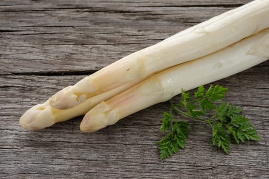 Asparagus white and raw with green chervil as a close-up