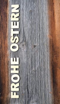 Happy Easter on a wooden background