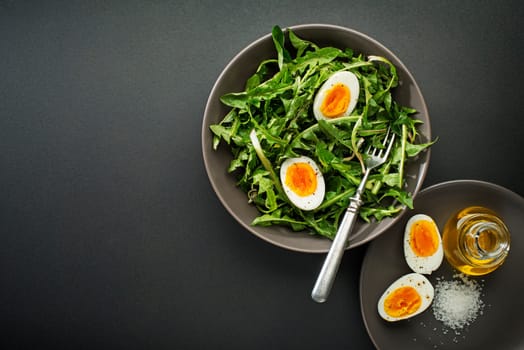 Fresh healthy dandelion salad with eggs overhead shoot