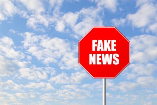 Stop fake news road sign against blue sky
